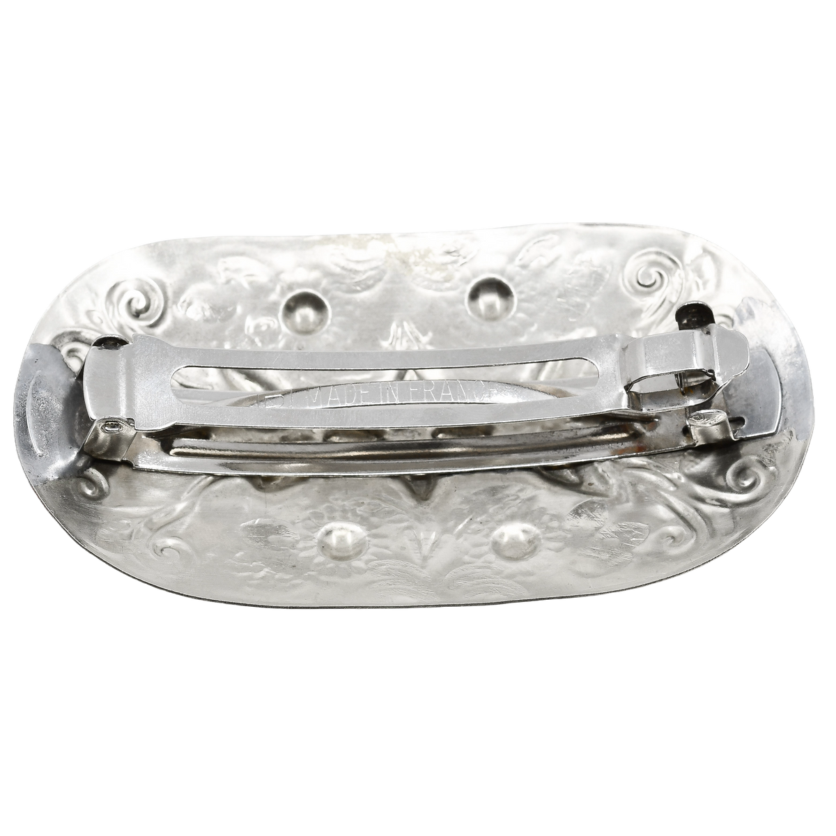 An Oval Silver Navajo Hair Barrette with decorations of Leaf and Flower Stamp work and Repousse