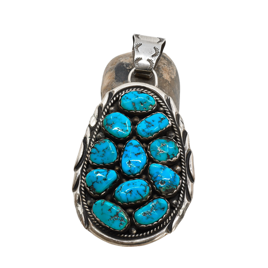 Turquoise stone pendant on a white background