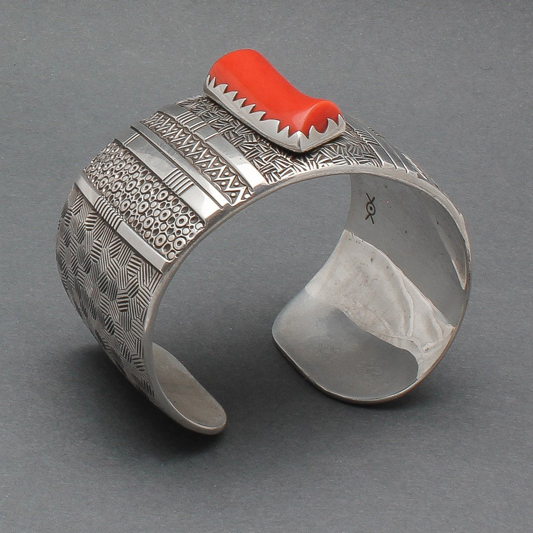 Norbert Peshlakai Wide Silver Stamped Bracelet With Coral Stone 