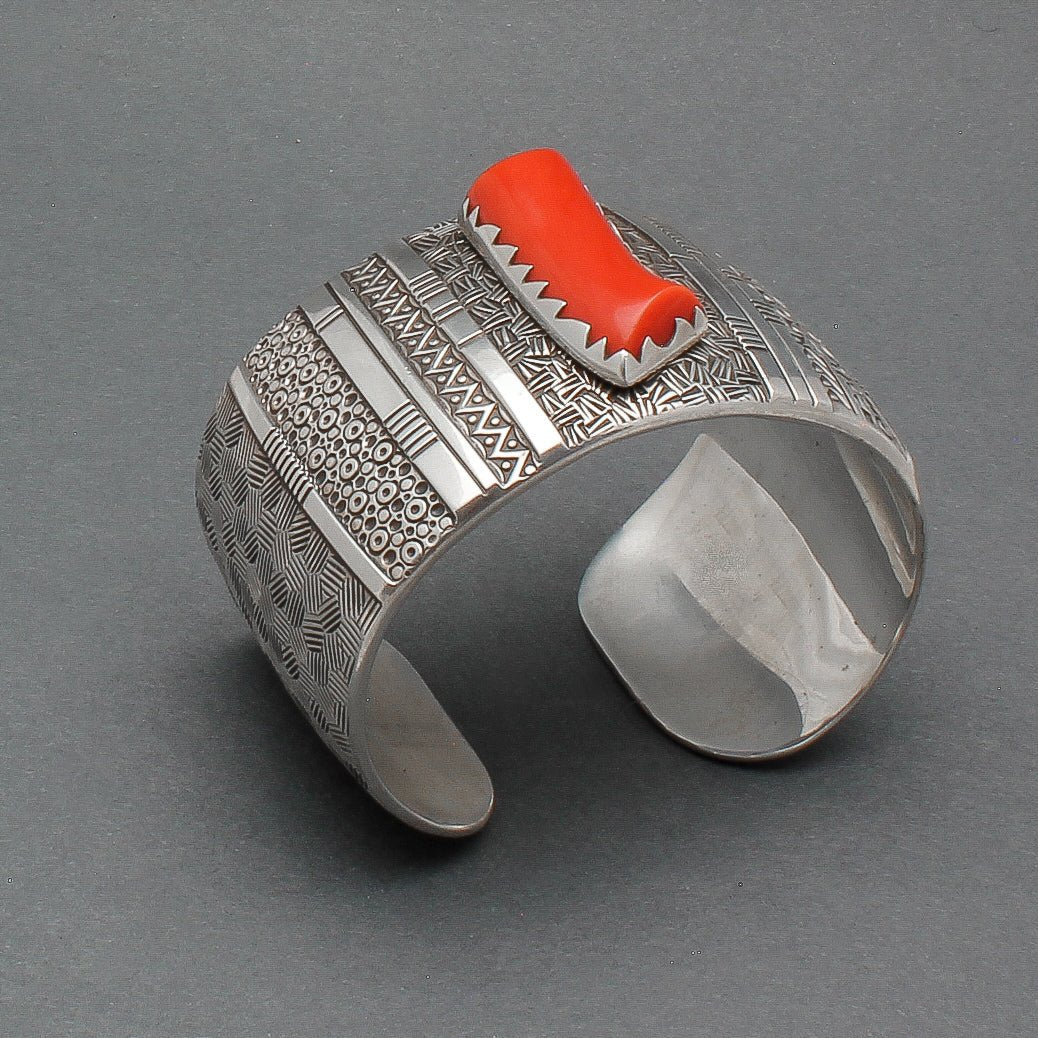 Norbert Peshlakai Wide Silver Stamped Bracelet With Coral Stone 